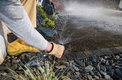 Technician adjusting irrigation controller